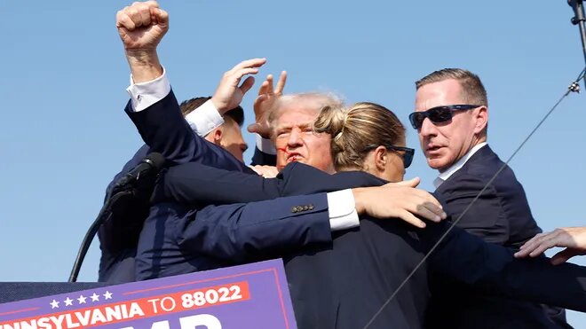 trump raising hand after being shot